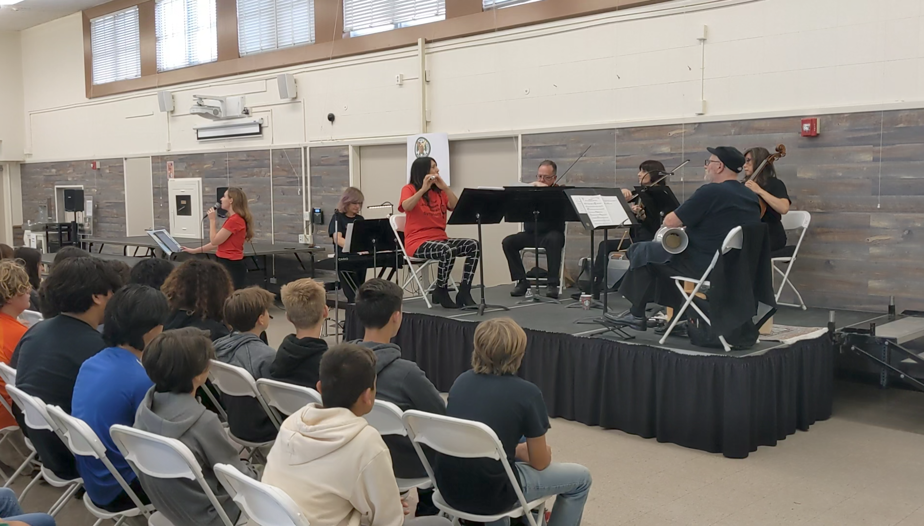 The LAJS chamber ensemble on stage in the cafeteria at John Muir Middle School.